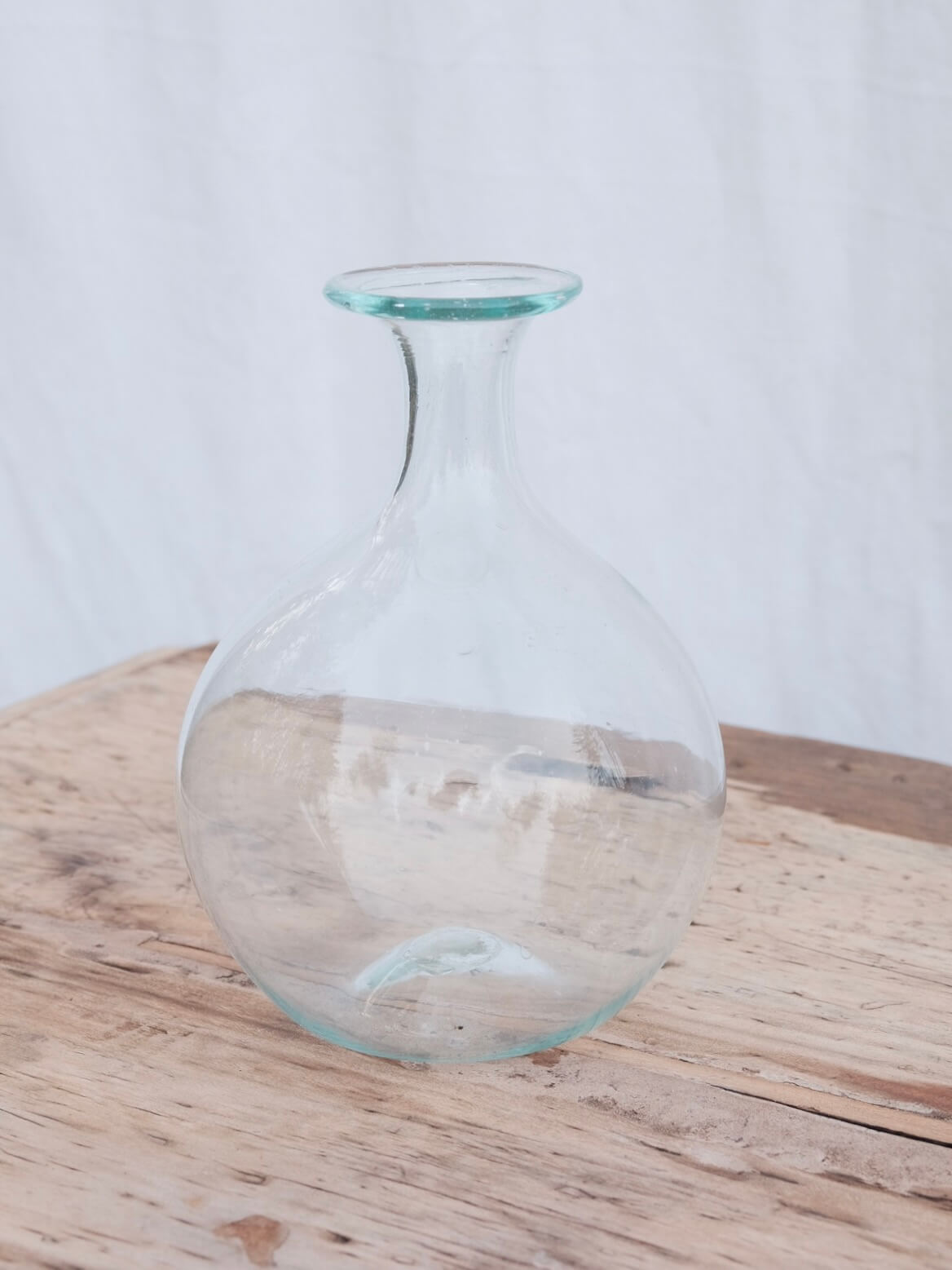 Round hand blown carafe with a lipped top. Handblown in Paris by La Soufflerie.
