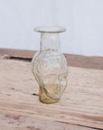 Small clear glass vase in the shape of a head. Use it as a vase, candleholder or creamer. Handblown in Paris by La Soufflerie.