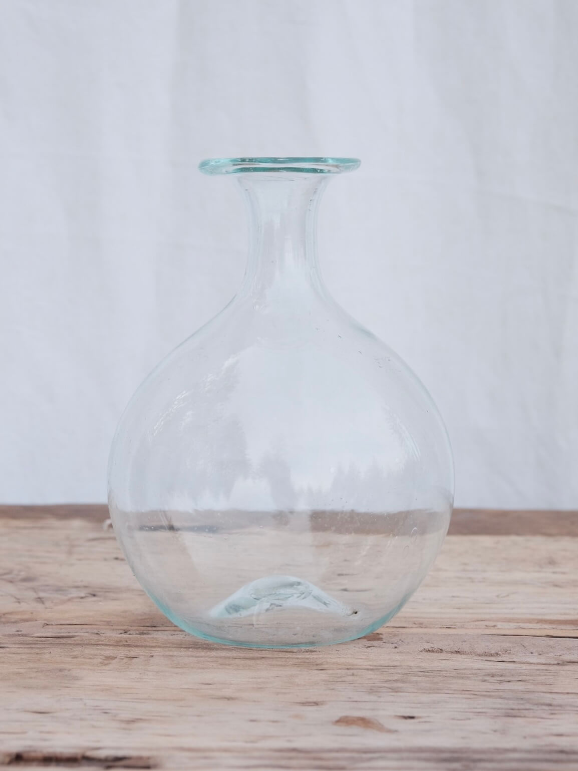 Round hand blown carafe with a lipped top. Handblown in Paris by La Soufflerie.